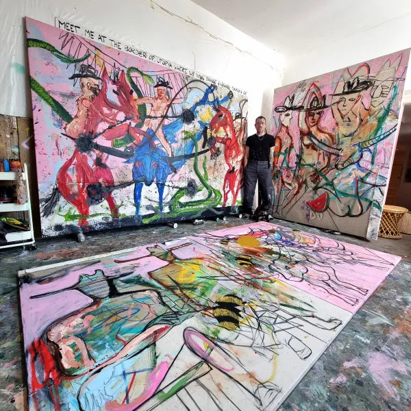 Kyte Tatt with three large canvases in his studio
