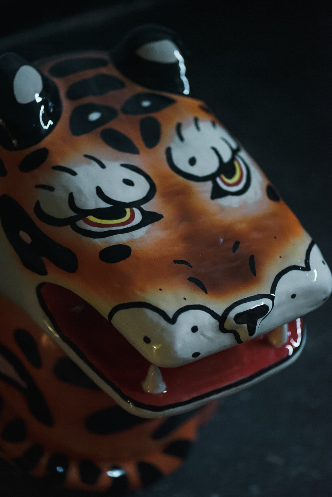 Close-up of a hand-painted stoneware leopard by Julia Staflund