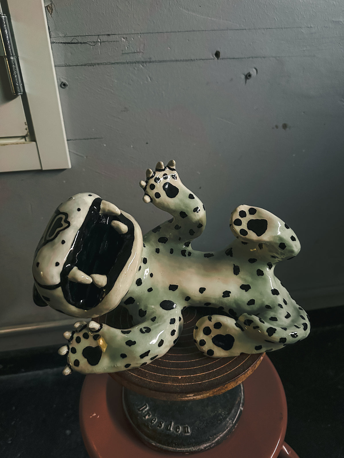 Spotted stoneware leopard lying on its back, by Julia Staflund