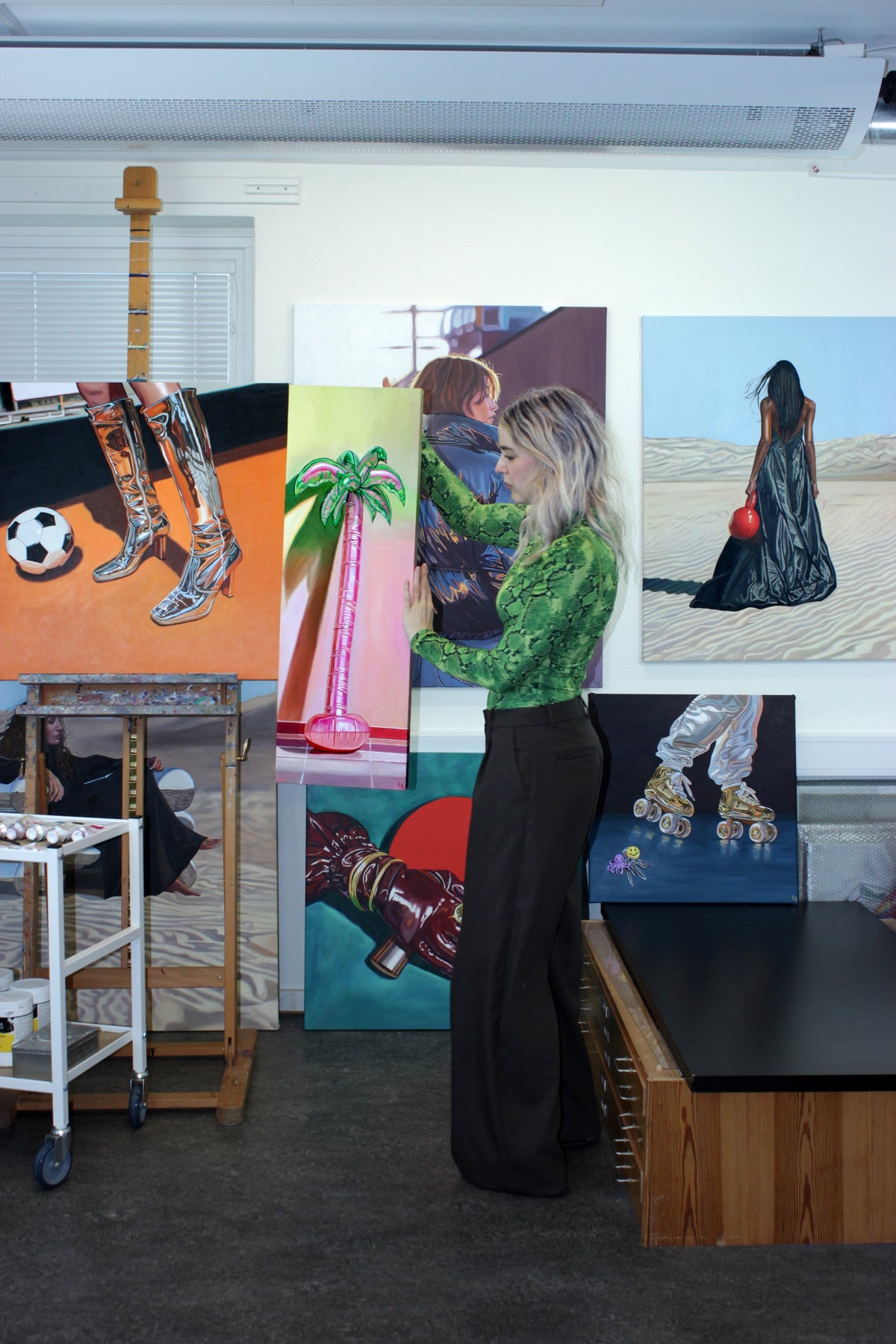 Lovisa Sköld with her paintings in the studio