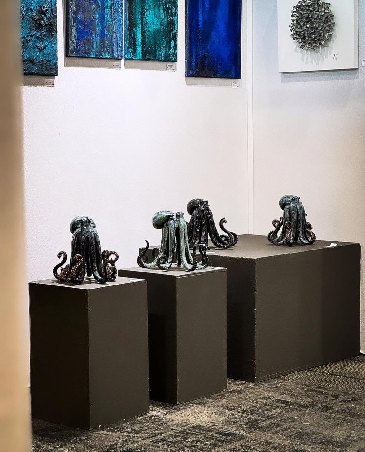 Octopus sculptures by Mia Alajasko on dark plinths, Paris 2024