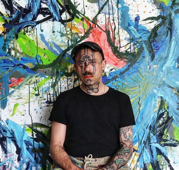 Kyte Tatt in front of one of his paintings